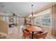 Sun-filled dining area with an elegant chandelier and tile flooring at 3760 82Nd Avenue E Cir # 101, Sarasota, FL 34243