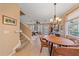 Open-concept dining room with adjacent staircase and view into living room at 3760 82Nd Avenue E Cir # 101, Sarasota, FL 34243