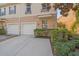Townhome featuring a two-car garage and manicured landscaping at 3760 82Nd Avenue E Cir # 101, Sarasota, FL 34243