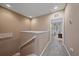 Hallway with carpeted floors, beige walls, and a view into a bedroom at 3760 82Nd Avenue E Cir # 101, Sarasota, FL 34243