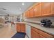 Open kitchen view with white appliances, wood cabinets, and tile flooring at 3760 82Nd Avenue E Cir # 101, Sarasota, FL 34243