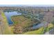 Scenic aerial view of a tranquil pond surrounded by lush greenery at 3760 82Nd Avenue E Cir # 101, Sarasota, FL 34243