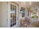 Charming covered front porch with seating and view at 3760 82Nd Avenue E Cir # 101, Sarasota, FL 34243