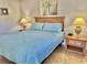 Comfortable bedroom featuring a queen bed, two lamps, tile floors and neutral walls at 4440 47Th W Ave # 204, Bradenton, FL 34210