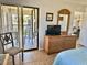 Bedroom boasts dresser, TV, large mirror and access to a private balcony with chairs at 4440 47Th W Ave # 204, Bradenton, FL 34210