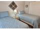 Bright bedroom with two twin beds with light blue bedding and a shared nightstand at 4440 47Th W Ave # 204, Bradenton, FL 34210