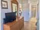 Bright bedroom featuring a television on a dresser and a mirror at 4440 47Th W Ave # 204, Bradenton, FL 34210