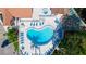Aerial view of the community pool with lounge chairs, tables, and lush greenery, offering a resort-like experience at 4440 47Th W Ave # 204, Bradenton, FL 34210