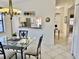 Bright dining area with chandelier lighting and an open view to the front entry hallway at 4440 47Th W Ave # 204, Bradenton, FL 34210