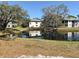 Scenic view of the building complex reflected on the tranquil pond with mature trees under a clear blue sky at 4440 47Th W Ave # 204, Bradenton, FL 34210