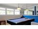 The game room features a pool table, windows, neutral and blue-painted walls, and overhead lighting at 4440 47Th W Ave # 204, Bradenton, FL 34210