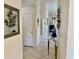 Bright hallway with tile flooring, decorative mirrors, and a glimpse into the living area at 4440 47Th W Ave # 204, Bradenton, FL 34210