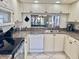Efficient kitchen with stainless steel appliances, white cabinetry, and breakfast bar pass-through at 4440 47Th W Ave # 204, Bradenton, FL 34210