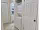 Laundry closet with stacked washer and dryer off the hallway at 4440 47Th W Ave # 204, Bradenton, FL 34210