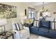 Open-concept living room featuring modern decor, including a blue sofa and artwork at 4440 47Th W Ave # 204, Bradenton, FL 34210