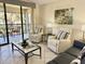 Inviting living room with comfortable seating and sliding glass doors to the patio at 4440 47Th W Ave # 204, Bradenton, FL 34210