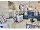 Inviting living room featuring a plush blue sofa and chairs, tile flooring, and bright natural light at 4440 47Th W Ave # 204, Bradenton, FL 34210