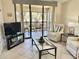 Bright living room with stylish decor, patio access, and plenty of natural light at 4440 47Th W Ave # 204, Bradenton, FL 34210