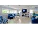 Inviting lounge area featuring comfortable seating, bookshelves, and a large-screen television at 4440 47Th W Ave # 204, Bradenton, FL 34210