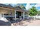 Outdoor seating area with tables and chairs, with the ping pong table nearby, under a wooden pavilion at 4440 47Th W Ave # 204, Bradenton, FL 34210