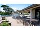 Outdoor seating area with iron tables and chairs, with the pool nearby, under a wooden pavilion at 4440 47Th W Ave # 204, Bradenton, FL 34210