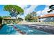 Community shuffleboard courts and seating area with lush landscaping on a bright, sunny day at 4440 47Th W Ave # 204, Bradenton, FL 34210