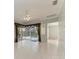 Bright living room with tile flooring and sliding glass doors to the pool area at 4524 Swordfish Dr, Bradenton, FL 34208