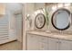Bathroom boasts double sinks with granite counters, updated vanity, and walk-in closet at 4712 Glenbrooke Dr, Sarasota, FL 34243