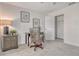 Neutral bedroom with carpeted floor, closet, lamp, and desk with wall art above it at 4712 Glenbrooke Dr, Sarasota, FL 34243