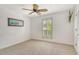 Bedroom includes carpeted floor, ceiling fan, and shuttered window offering lots of natural light at 4712 Glenbrooke Dr, Sarasota, FL 34243