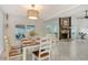 Dining room featuring a wooden table, seating for six, and a view to the fireplace, creating an inviting ambiance at 4712 Glenbrooke Dr, Sarasota, FL 34243