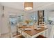 Cozy dining room with a view of the pool, featuring a wooden table, six chairs, and bright, natural lighting at 4712 Glenbrooke Dr, Sarasota, FL 34243