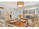 Dining room with a wooden table set for dinner, open to a remodeled kitchen, ideal for Gathering meals at 4712 Glenbrooke Dr, Sarasota, FL 34243