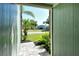 The view from the front door of a well maintained lawn, palm trees, and stone accents at 4712 Glenbrooke Dr, Sarasota, FL 34243