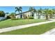 Home showcasing manicured lawn, swaying palm trees, and stone accents enhancing the curb appeal at 4712 Glenbrooke Dr, Sarasota, FL 34243