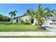 Charming home with lush lawn, mature palms and stone accents creating inviting curb appeal at 4712 Glenbrooke Dr, Sarasota, FL 34243