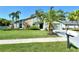Charming home with lush lawn, lovely palms and stone accents creating inviting curb appeal at 4712 Glenbrooke Dr, Sarasota, FL 34243