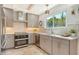 Modern kitchen with stainless steel appliances, white countertops, and stylish cabinets, ideal for cooking enthusiasts at 4712 Glenbrooke Dr, Sarasota, FL 34243