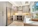 Bright kitchen features stainless steel appliances, light wood cabinets, tile floor, and quartz counters at 4712 Glenbrooke Dr, Sarasota, FL 34243