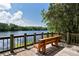 Tranquil lake view from a wooden deck, offering a peaceful retreat and scenic beauty at 4712 Glenbrooke Dr, Sarasota, FL 34243