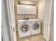 Laundry area with washer and dryer, overhead cabinets, and tiled floor at 4712 Glenbrooke Dr, Sarasota, FL 34243