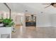 Bright living room with tile flooring, a built-in bar, and entryway view, creating an inviting and functional space at 4712 Glenbrooke Dr, Sarasota, FL 34243