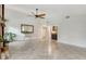 Open living room with tile floors, a stone fireplace, high ceilings, and a small bar area, offering space and charm at 4712 Glenbrooke Dr, Sarasota, FL 34243