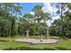Community playground amidst mature trees, creating a safe and inviting space for outdoor fun at 4712 Glenbrooke Dr, Sarasota, FL 34243
