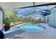 Screened pool with lounge chairs, and view of the manicured yard at 4712 Glenbrooke Dr, Sarasota, FL 34243