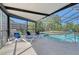Screened pool area with lounge chairs and lush garden views at 4712 Glenbrooke Dr, Sarasota, FL 34243