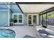 Relaxing pool patio featuring a spa, lounge chairs, and seamless indoor-outdoor living at 4712 Glenbrooke Dr, Sarasota, FL 34243
