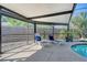 Screened pool with lounge chairs and a backyard view at 4712 Glenbrooke Dr, Sarasota, FL 34243