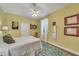 Bright bedroom with a cozy bed, colorful rug, and natural light from the window at 4811 Summertree Rd, Venice, FL 34293
