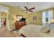 Bright bedroom featuring a ceiling fan, natural light, and wooden floors at 4811 Summertree Rd, Venice, FL 34293